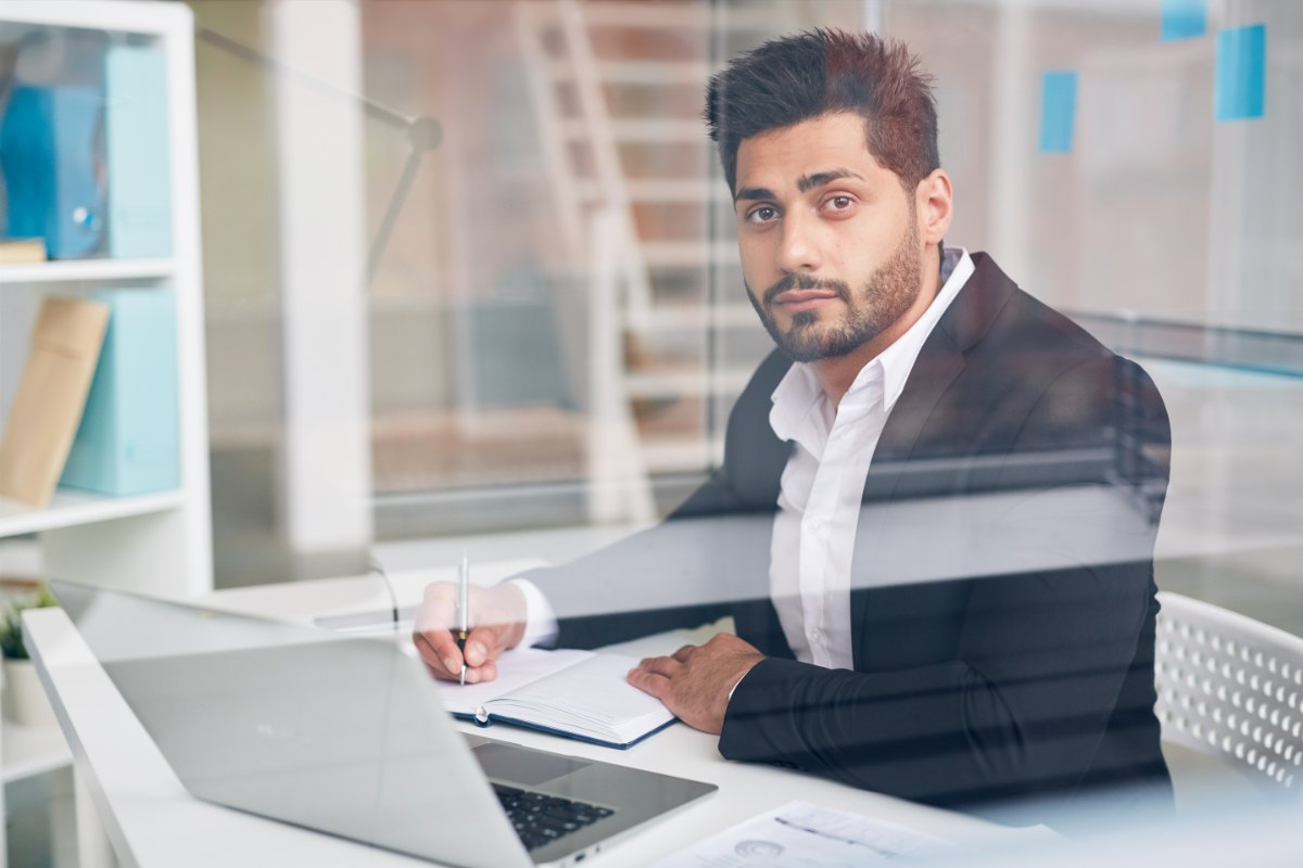 An advisor reviewing a client file at a desk