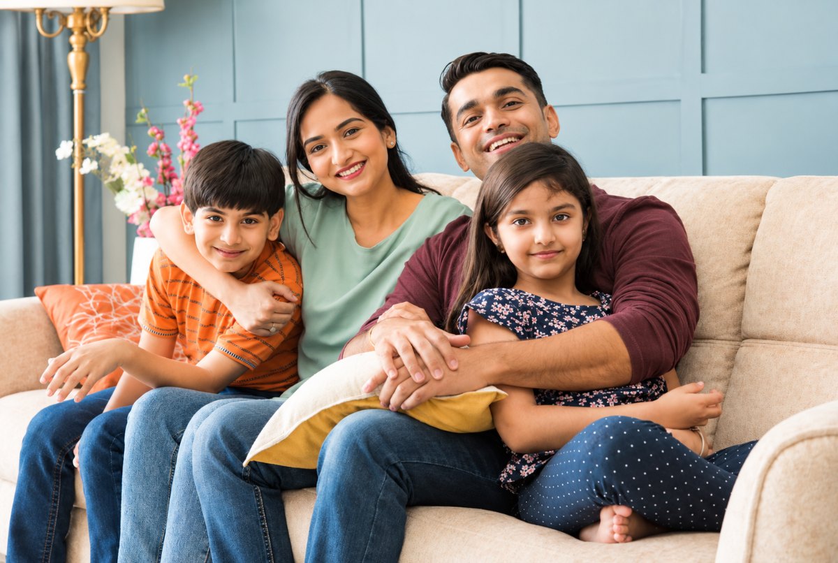Three generations of a family sitting together at home